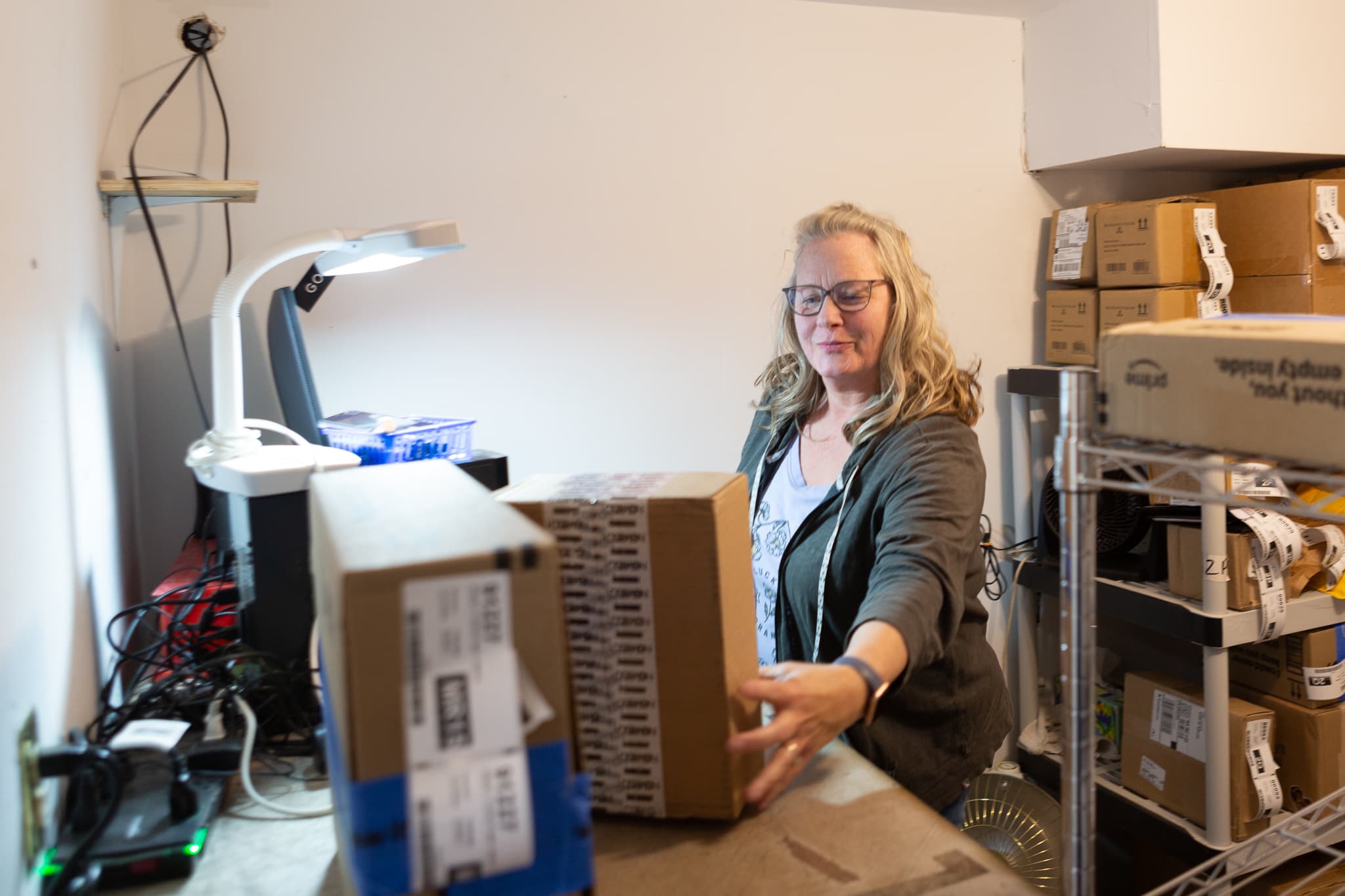 An employee entering a package into the Hagens system